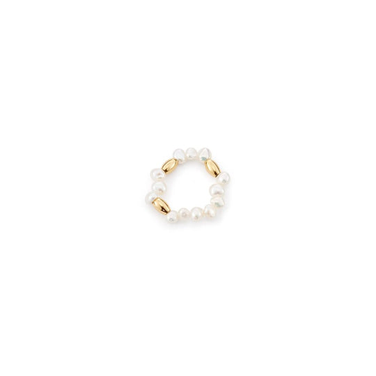 Clean white background overhead shot of elastic stretch beaded ring, lined with tiny smooth white oval freshwater pearls and polished 18k gold plated accent beads forming full circular band