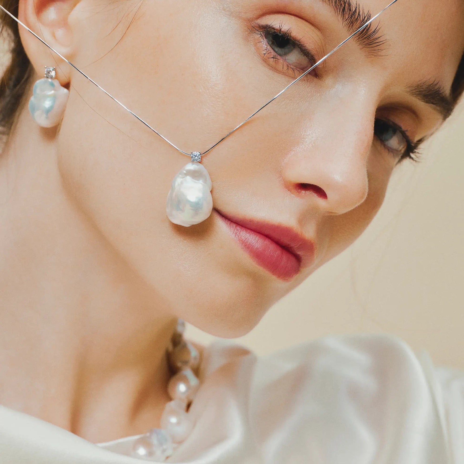 rainbow baroque pearl pendant and silver snake chain necklace close up look