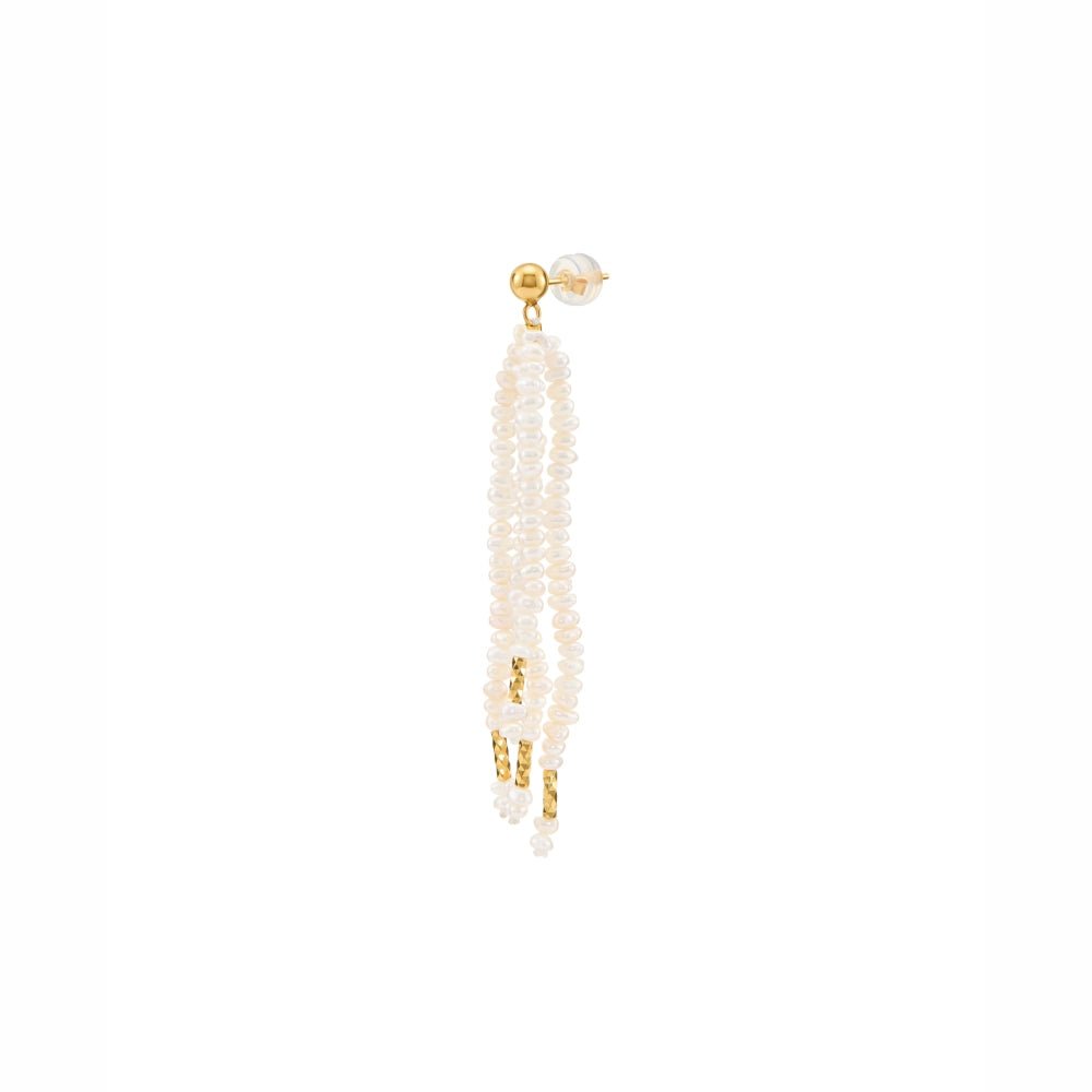 Vertical minimal white studio close up shot of single cascading multi-strand white oval pearl tassel drop earring with polished 18k gold plated hardware accents