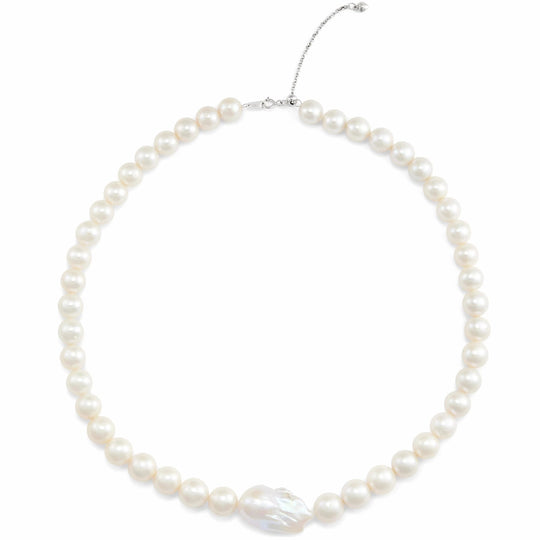 Overhead flat shot of sterling silver pearl choker, uniform round white pearls with one large baroque focal pearl, fitted with adjustable extender chain on plain white background