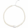Overhead flat shot of sterling silver pearl choker, uniform round white pearls with one large baroque focal pearl, fitted with adjustable extender chain on plain white background